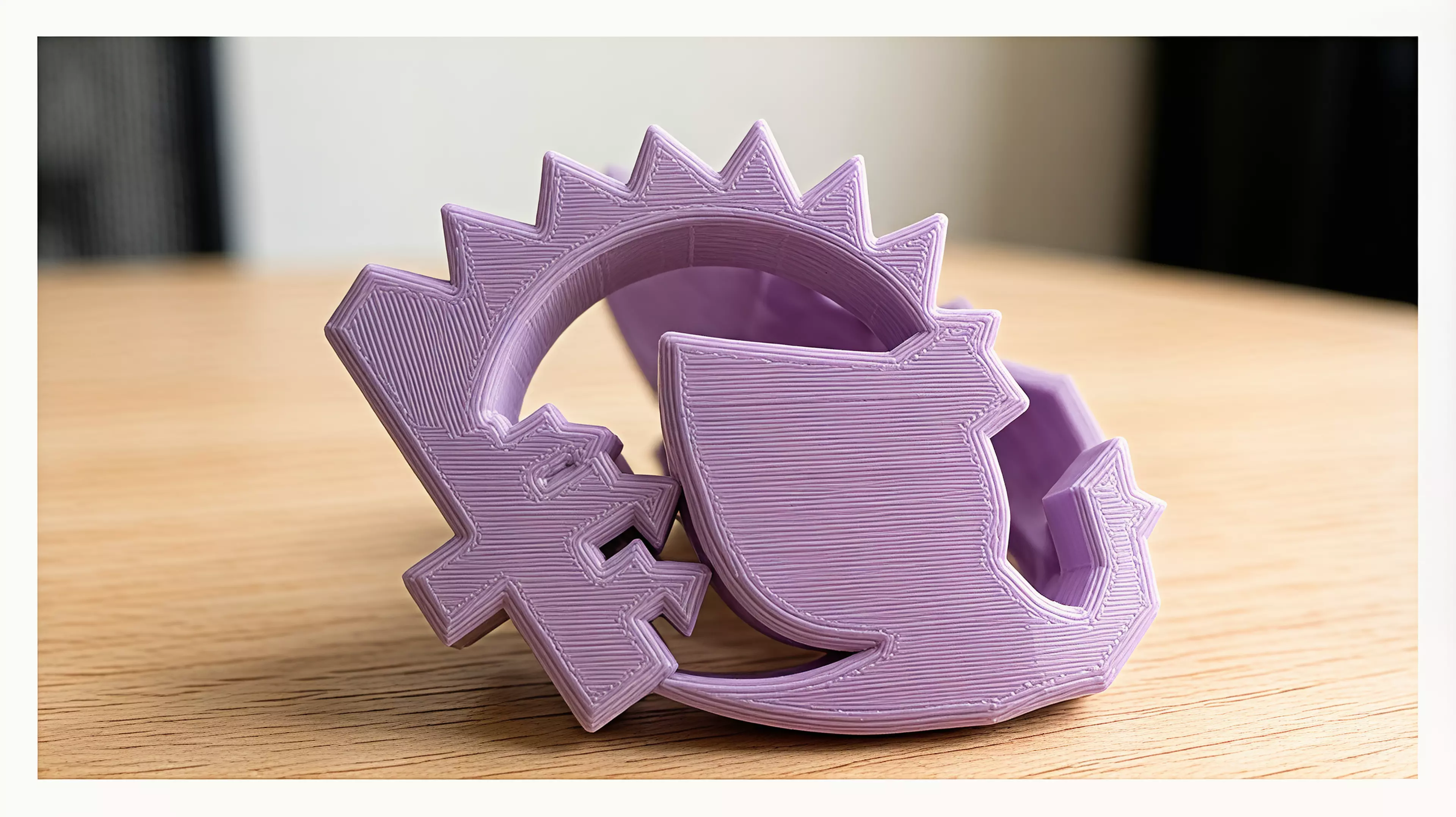 A palm-sized one-piece desk rocker designed to rest as a curled sleeping dragon, then reveal a castle-bearing crescent when gently rocked.