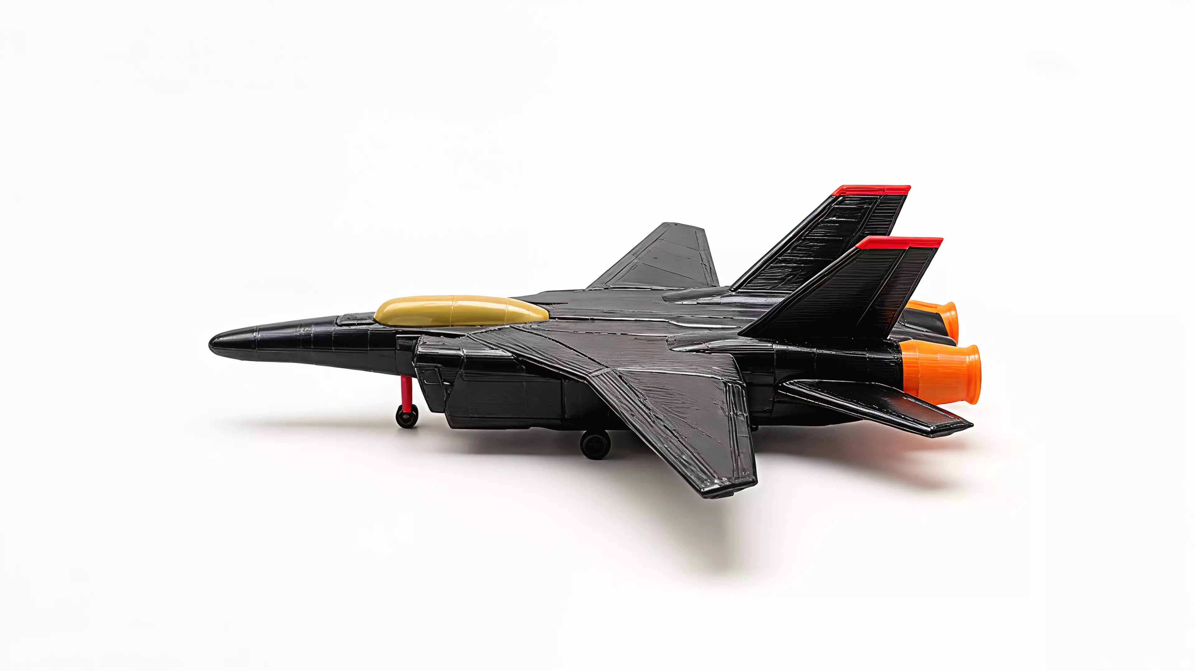 A 390 mm-wingspan F-14D Tomcat that sits on its own landing gear like a ramp-parked jet. Sixteen colour-separated printed parts - gloss-black airframe and spine deck, pale-khaki tandem canopy, red-tipped twin tails, red intake frames and nose strut, orange afterburner nozzles and a full tricycle gear - assemble into a spread-wing display pose. 390 x 388 x 117 mm (about 15.4 x 15.3 x 4.6 in).