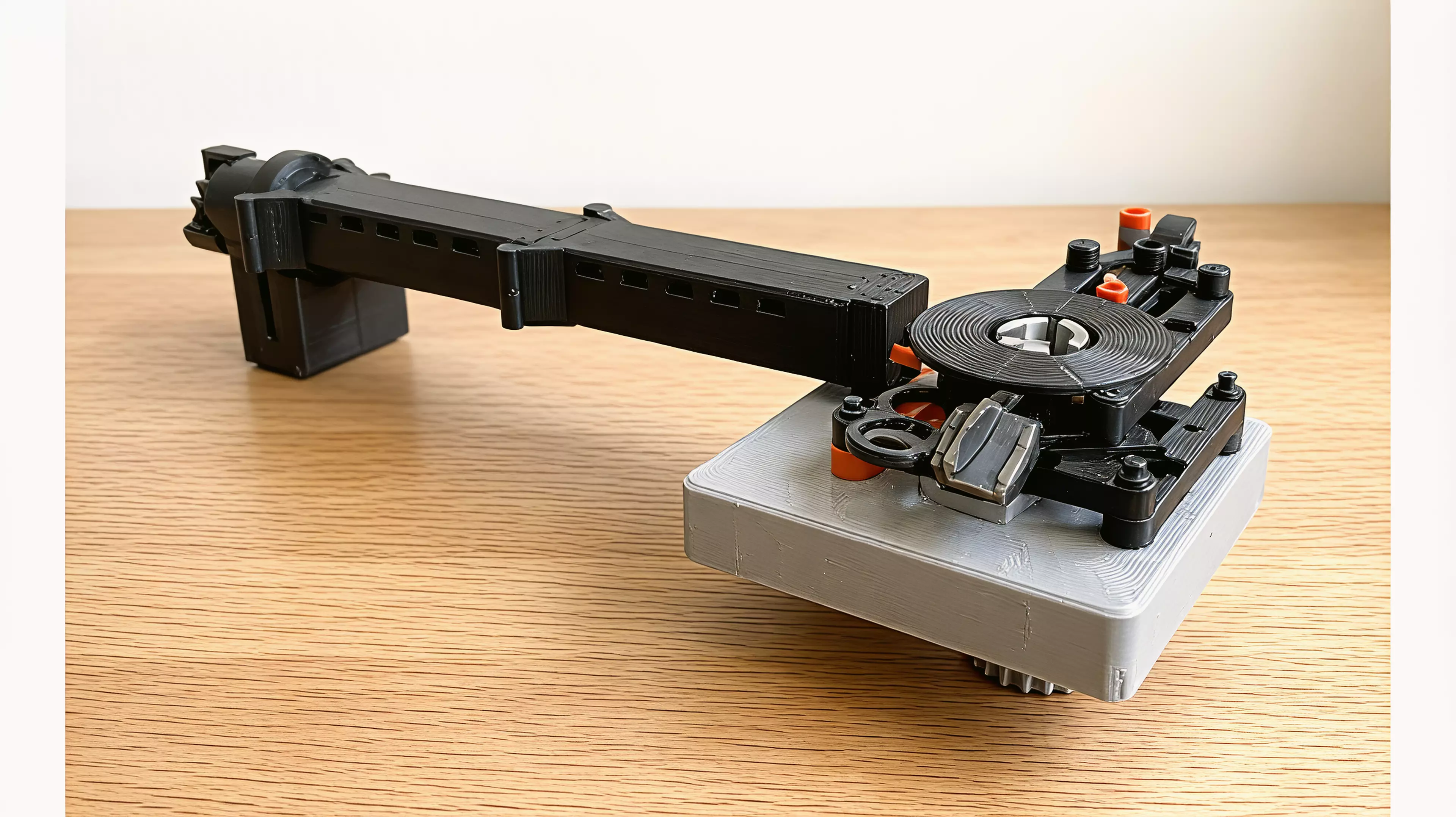 A bench-clamped manipulator that mirrors your hand at 2:1 - squeeze, twist and thumb-push drive a gimballed three-jaw gripper down a stackable boom, for steady, dexterous work inside aquariums, terrariums and tight chassis your hand cannot reach.