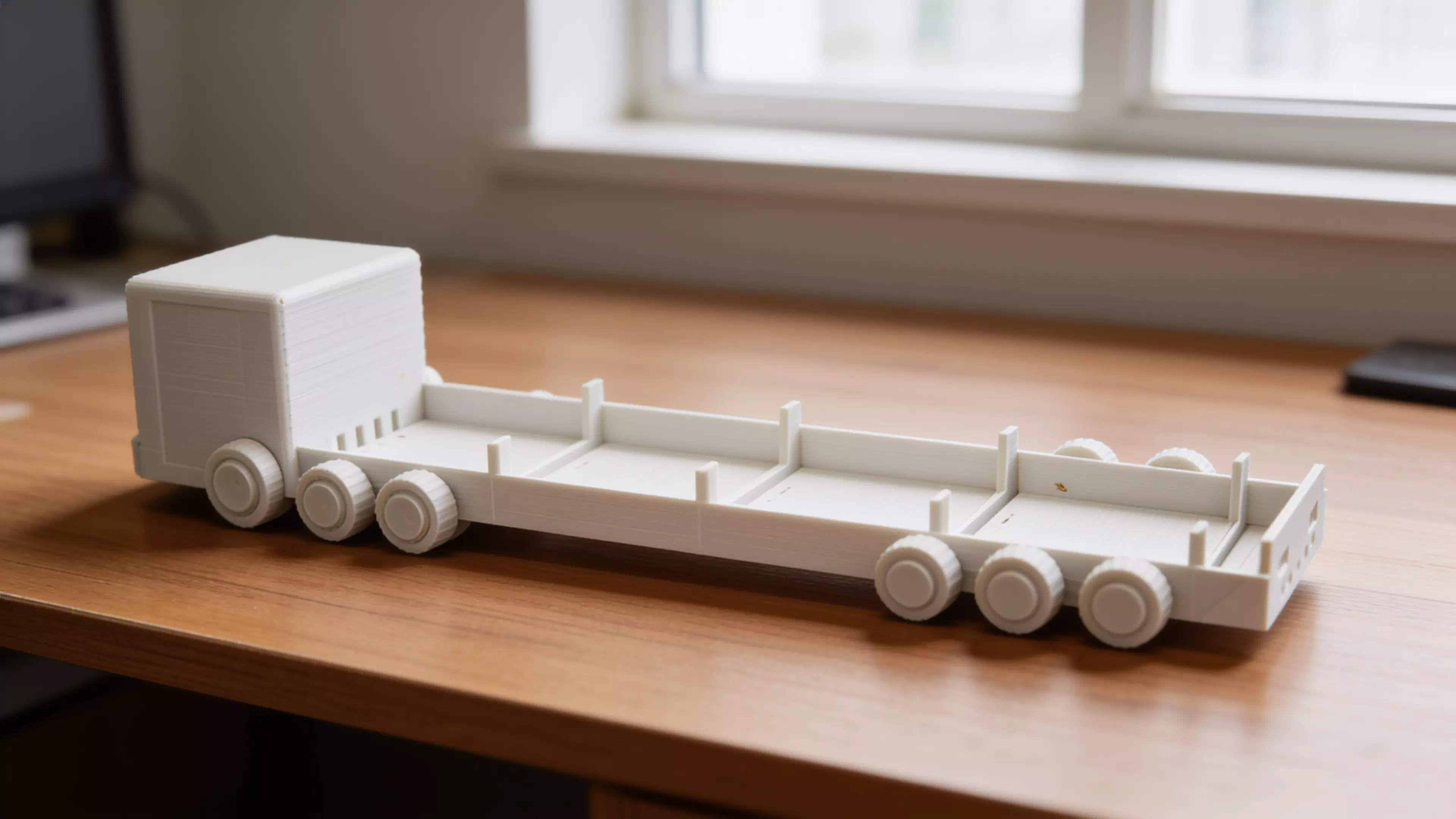 A pastel "future truck" desk shelf that carries 4 real DGX Spark units (150 × 150 × 50.5 mm) lying flat in a long row along the truck bed — built as a modular train of identical cargo bays between a cute pixel-face cab and a styled tail, on decorative six-wheel running gear.