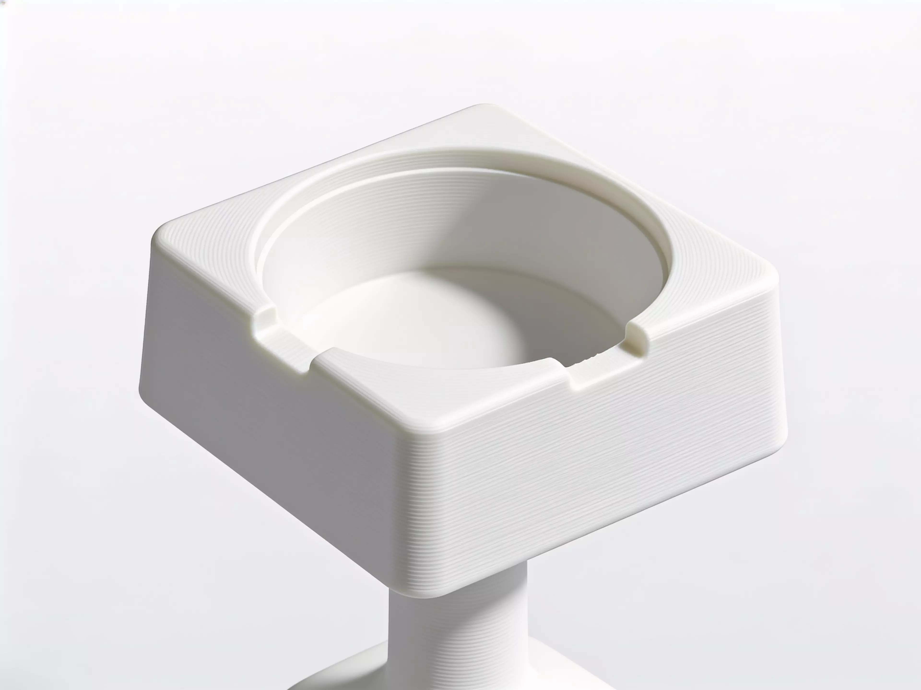 A single-piece, Scandinavian-minimal squircle stand (200 × 200 × 76 mm) that a standard 1-quart stainless bowl drops into from the top and hangs by its rolled rim on an internal support lip, with an anti-spill raised rim, two finger scallops for bowl removal, "NUNU" + paw icon raised on the front…