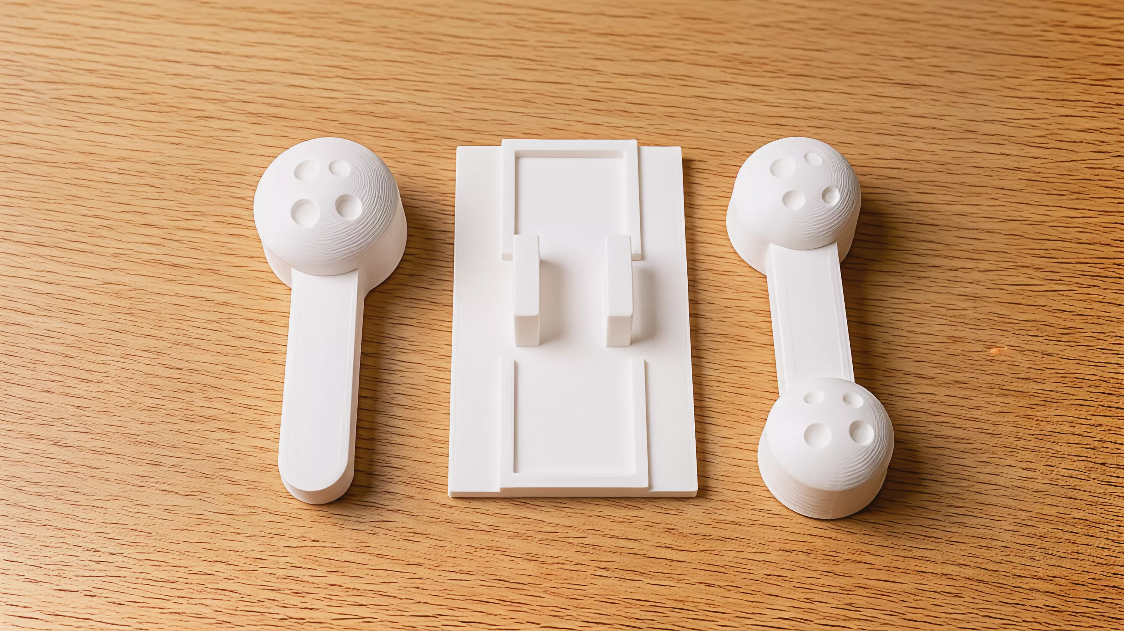 A palm-sized, three-part printable desk mechanism whose exposed rocker makes one cratered moon rise when the other is pressed.