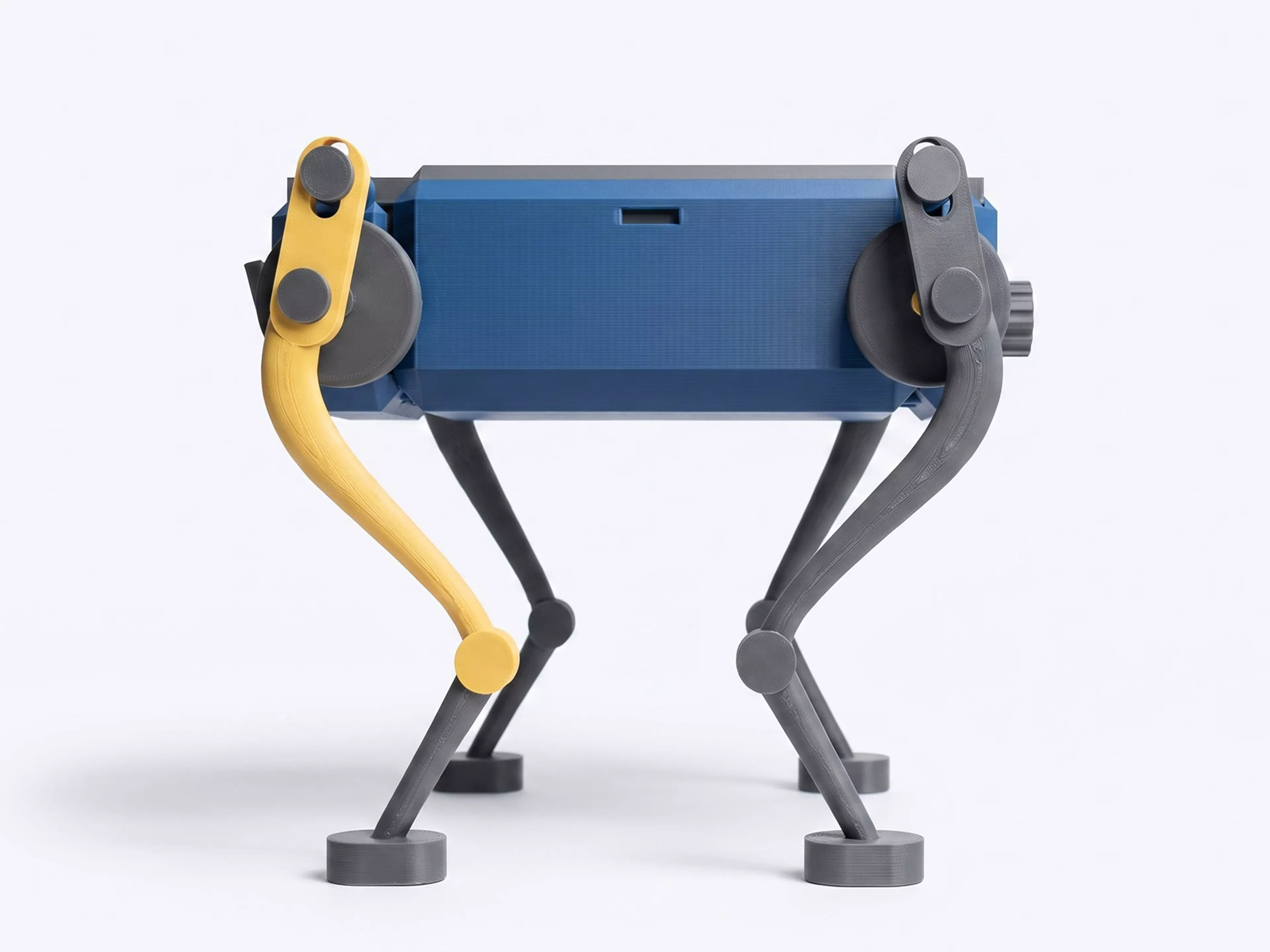 A palm-size wind-up walker. Twist the knob at the back to wind it up, set it down, and it trots forward on four legs with a smooth, life-like gait - no batteries, no motors. The rubber band inside drives two crankshafts that swing the legs in turn, so it keeps its balance step after step. Every part is 3D printed.