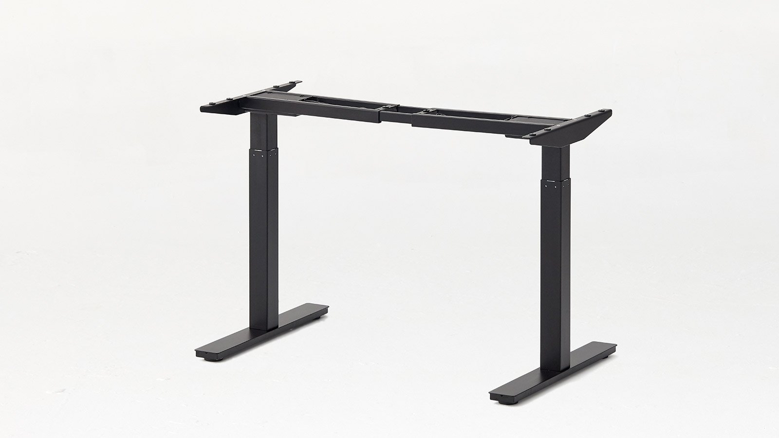 Product shot of the Autonomous SmartDesk Frame in black with the top exposed showing the mounting hole positions.