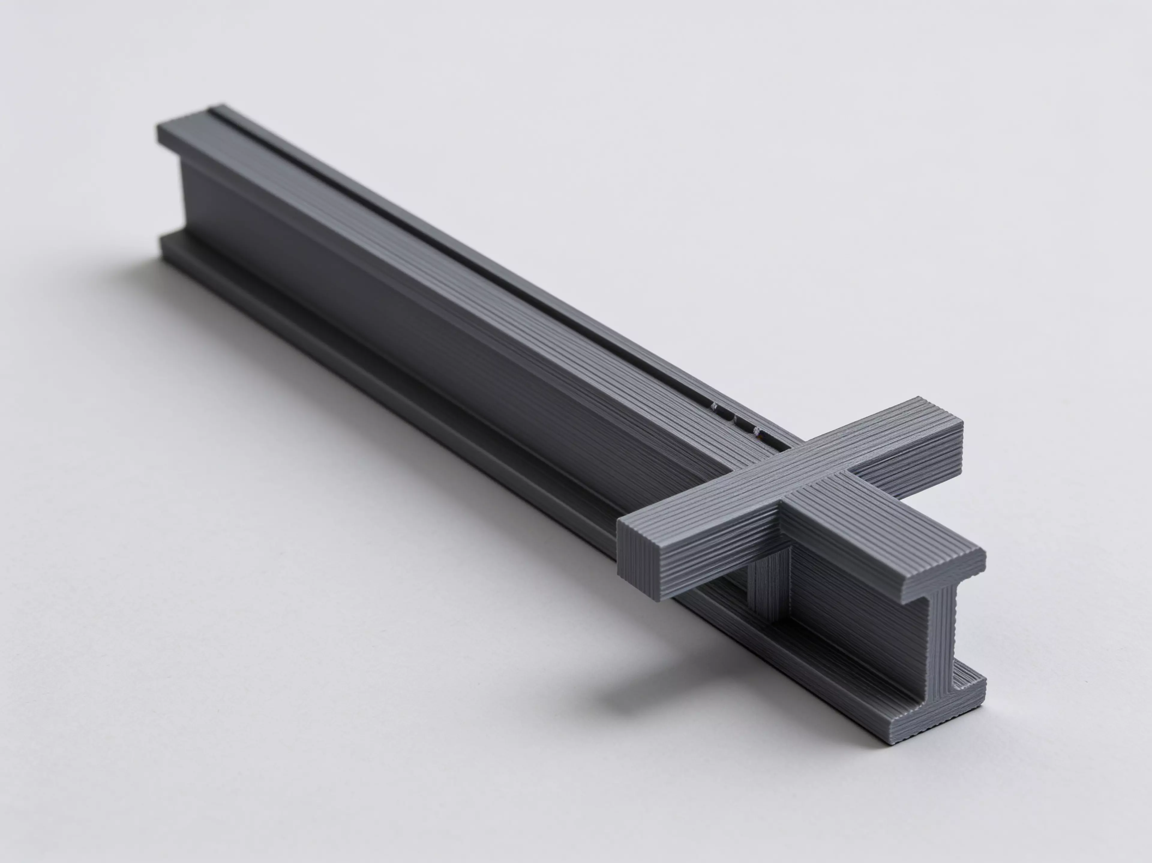 A sculpted Z-profile laptop stand designed around a 13" MacBook, tilted 22° for comfortable typing with a low-profile anti-slip ridge that catches the laptop's front edge. Two mirrored Z-legs — solid where they carry load, hex-relieved where they don't — are braced into a rigid box frame by four I-beam crossbars that press-fit straight into the legs. No screws, no heat-set inserts, no glue: just push the crossbars in and it locks together by friction alone.