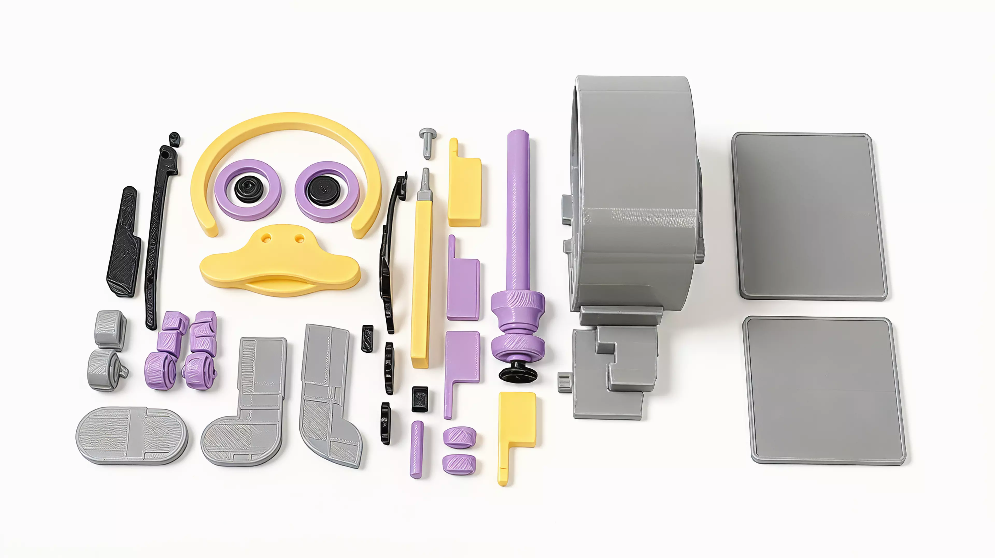 A grey robot duck with a yellow bill, purple details and a side winding knob. A replaceable silicone cord stores the twist that drives its small wheels.