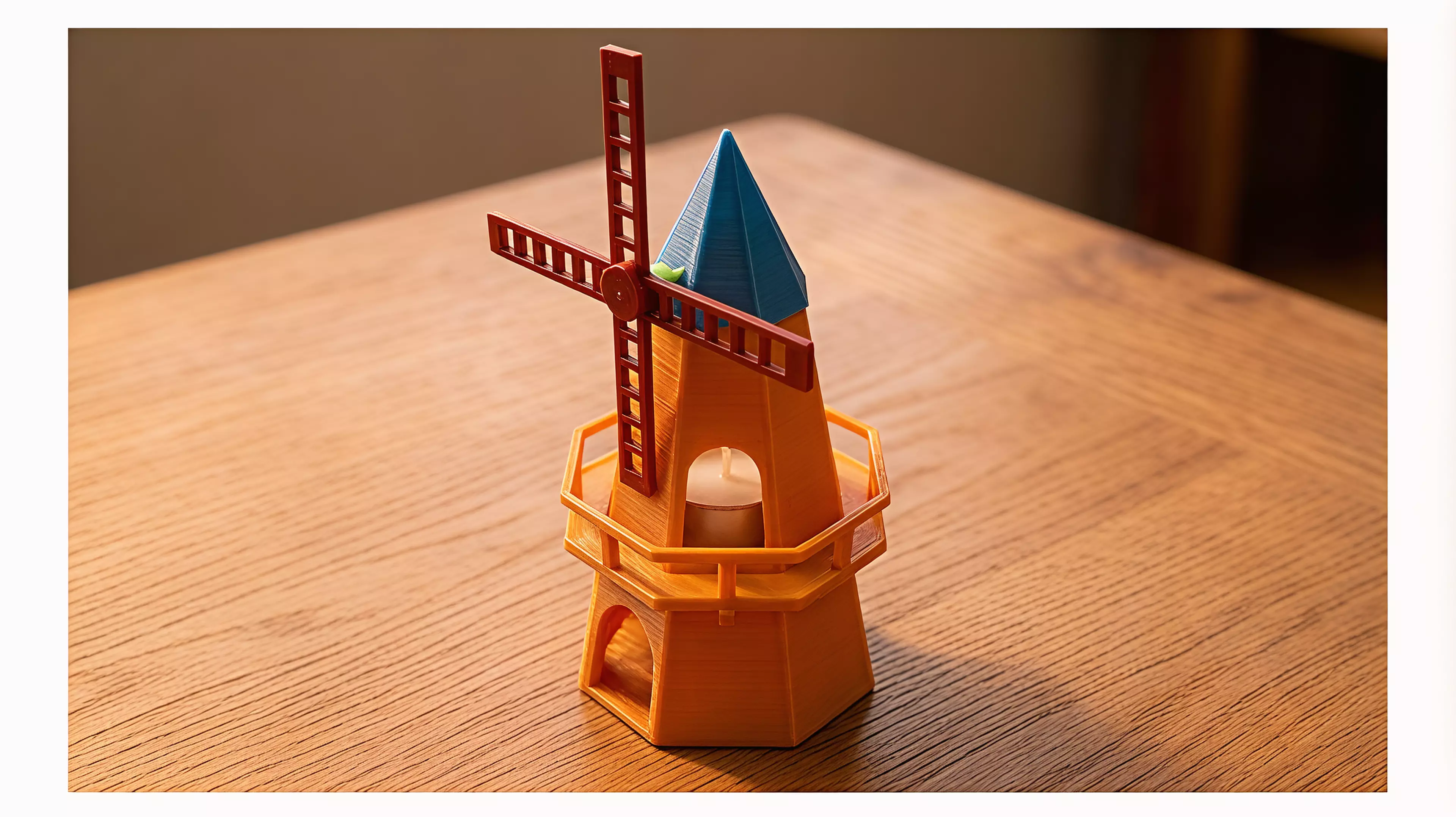 A ~250mm-tall desk windmill tea light holder in a minimal, crisp-edged style: a hollow tapered octagonal tower with an arched candle-access opening, a railed balcony, a conical cap, and a 4-blade lattice sail rotor that spins freely on a brass pin.
