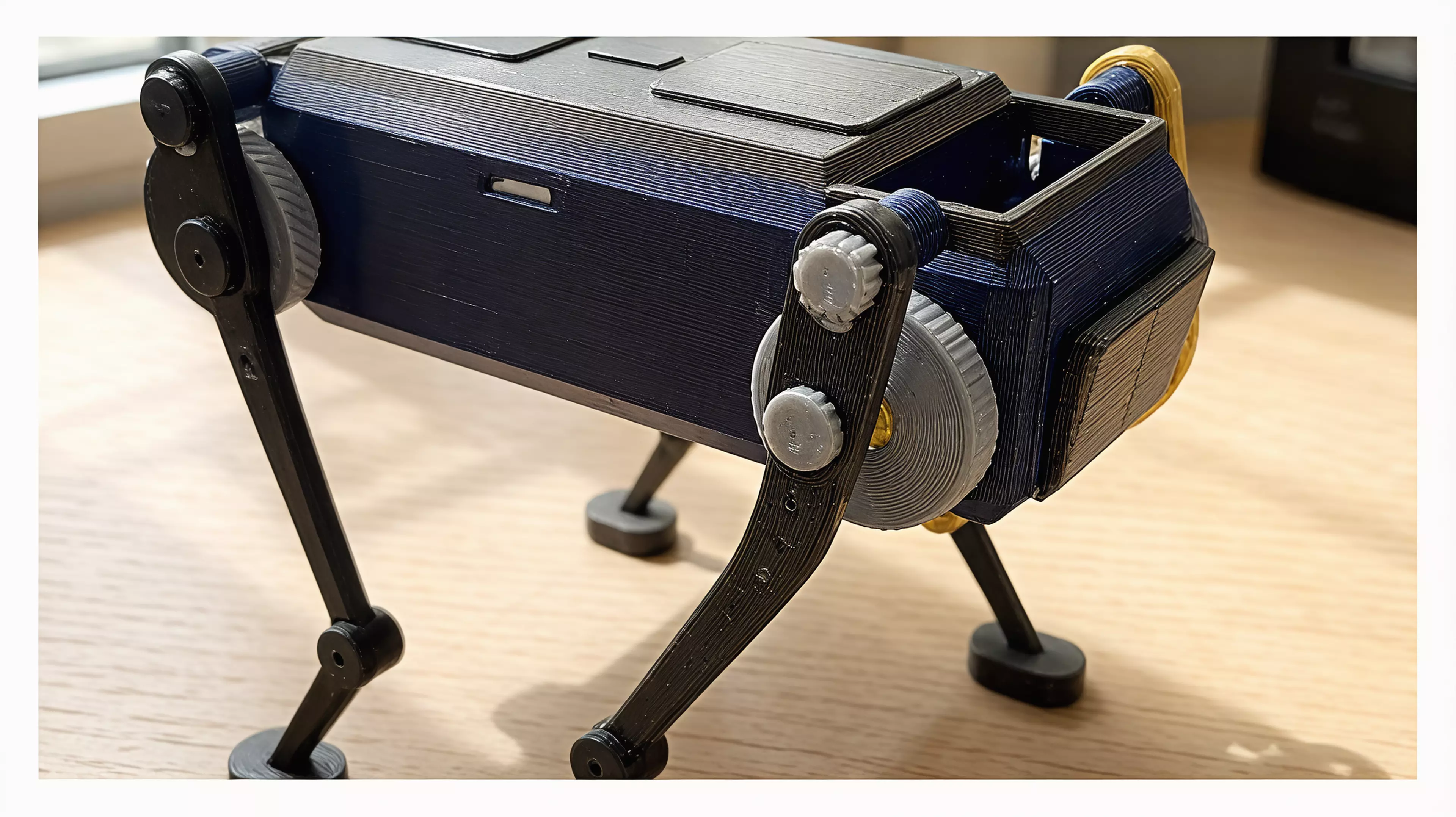 A palm-size wind-up walker. Twist the knob at the back to wind it up, set it down, and it trots forward on four legs with a smooth, life-like gait - no batteries, no motors. The rubber band inside drives two crankshafts that swing the legs in turn, so it keeps its balance step after step. Every part is 3D printed.