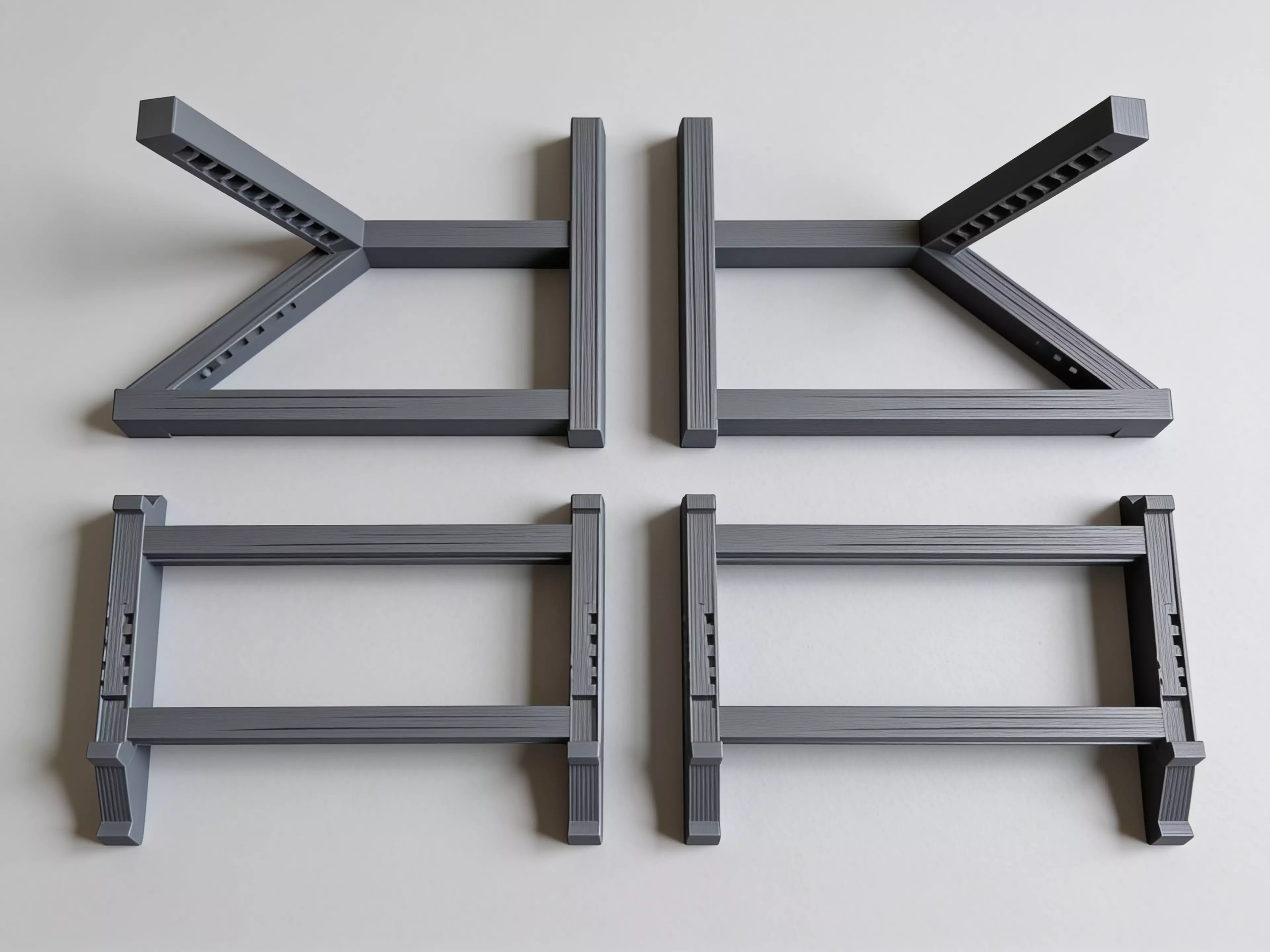 A sculpted Z-profile laptop stand designed around a 13" MacBook, tilted 22° for comfortable typing with a low-profile anti-slip ridge that catches the laptop's front edge. Two mirrored Z-legs — solid where they carry load, hex-relieved where they don't — are braced into a rigid box frame by four I-beam crossbars that press-fit straight into the legs. No screws, no heat-set inserts, no glue: just push the crossbars in and it locks together by friction alone.