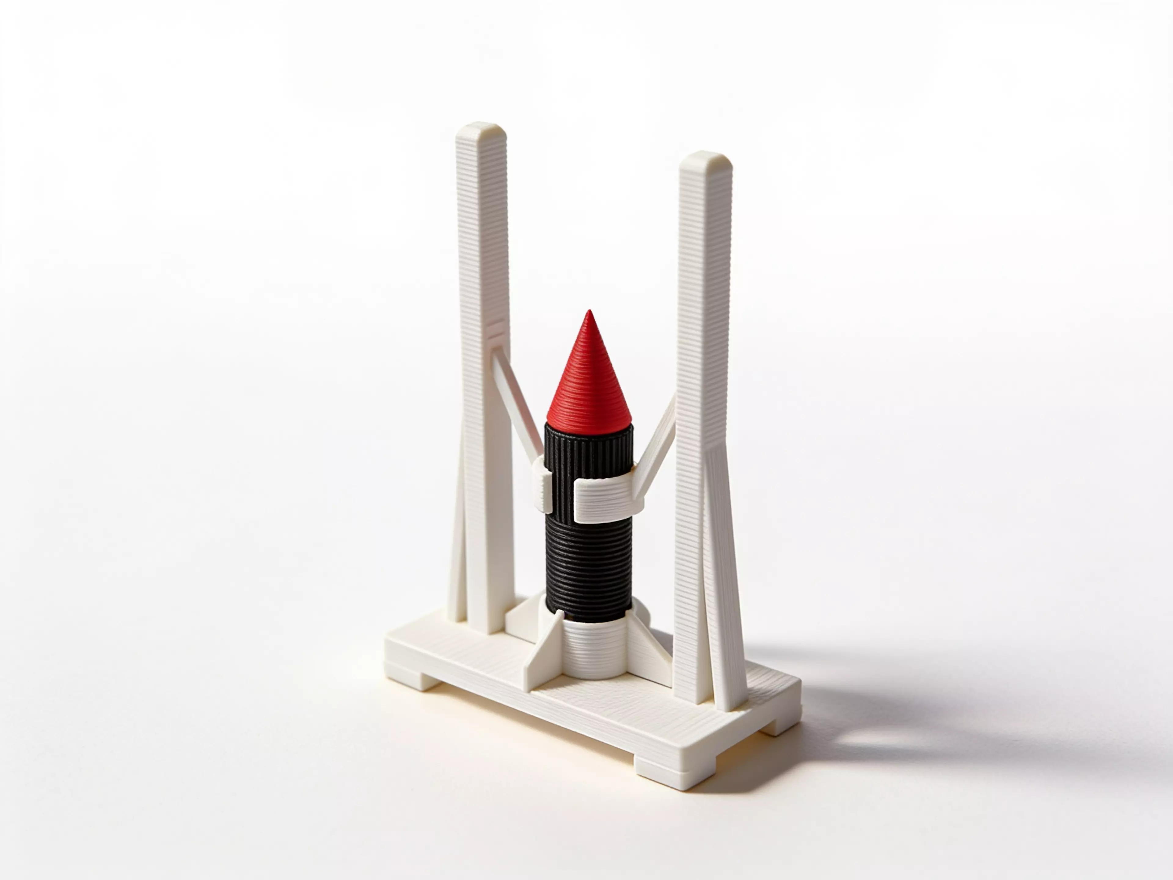 A 180 mm desktop model-rocket-on-launch-tower display: a natural-wood-tone launch tower cradling a removable tan/gray toy rocket, matching the reference photo's craft-model look.