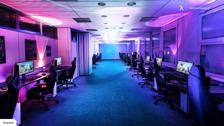 Interior of colorful modern gaming room with neon light. Playing