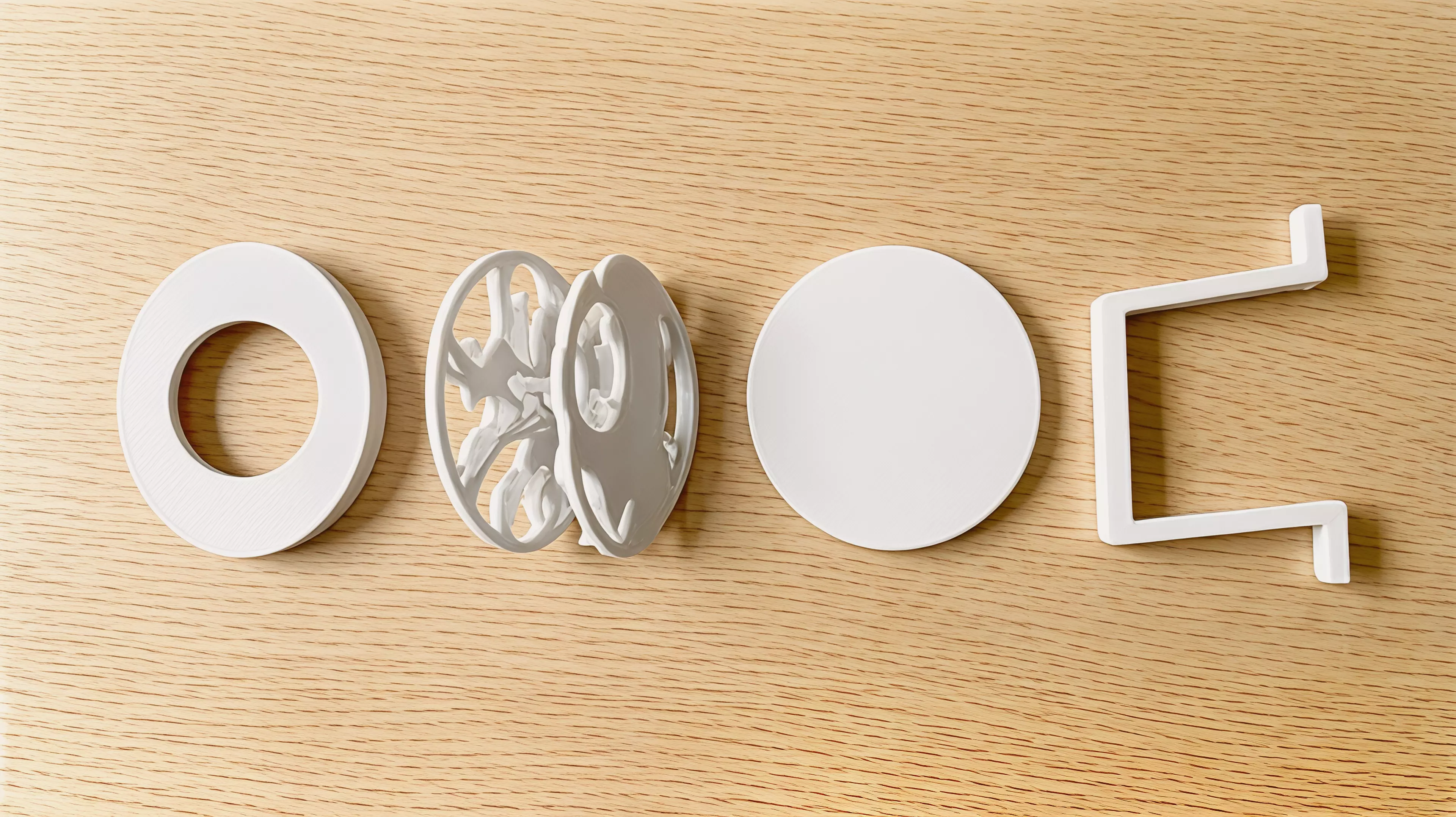 A four-part hand-powered moon gate with a captured reel that casts indexed rabbit, fox, and owl shadows from an ordinary external phone flashlight.