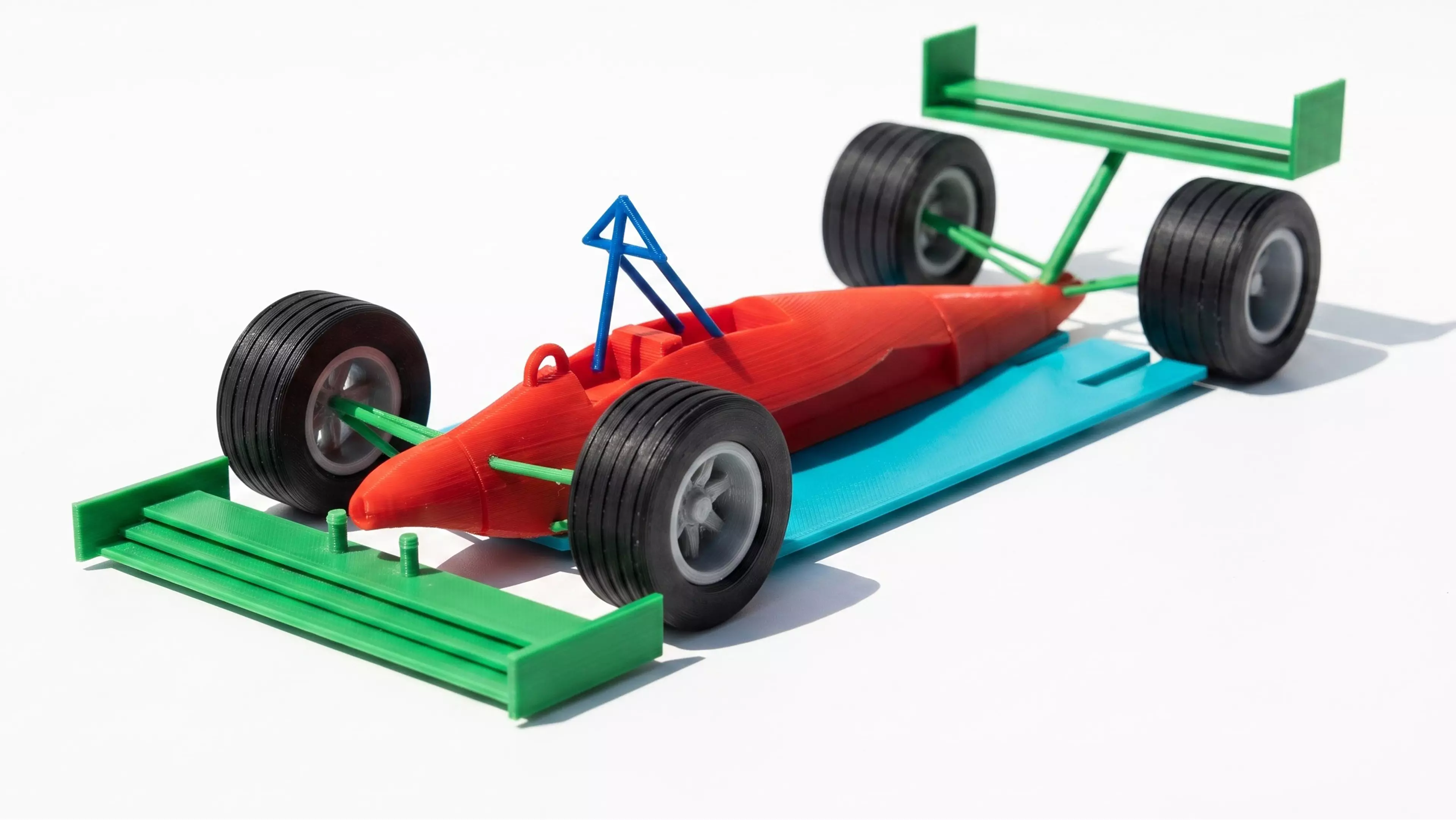 A 10-part, 17-piece 1:16 scale Mercedes-style F1 car: silver body shell (tub/nose/sidepods/engine cover with integrated suspension arms and axle stubs), black floor/diffuser, black front and rear wings, black halo, 4 rotatable wheels (2 rim + 2 tire designs, front/rear) with a center-lock retaining…