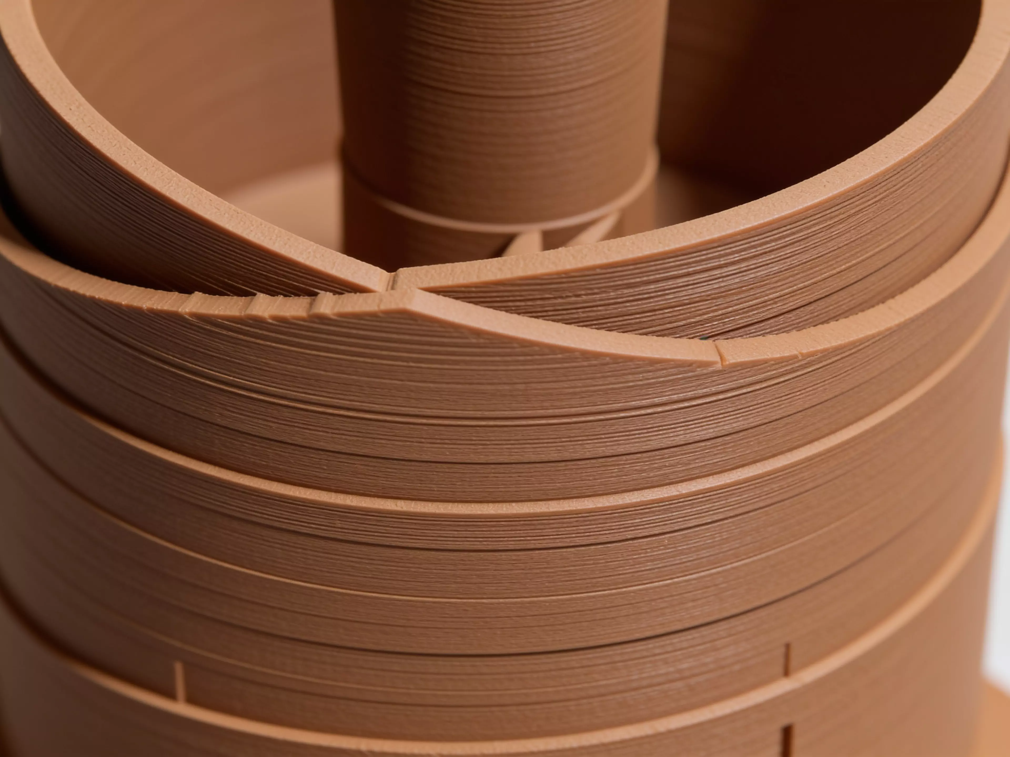 A 210 mm tall helical dice tower: a funnel hopper feeds dice onto a spiral ramp that winds 2.42 turns around a central pillar, contained by overlapping guide walls, exiting through a domed chute near the base onto an integrated landing tab.