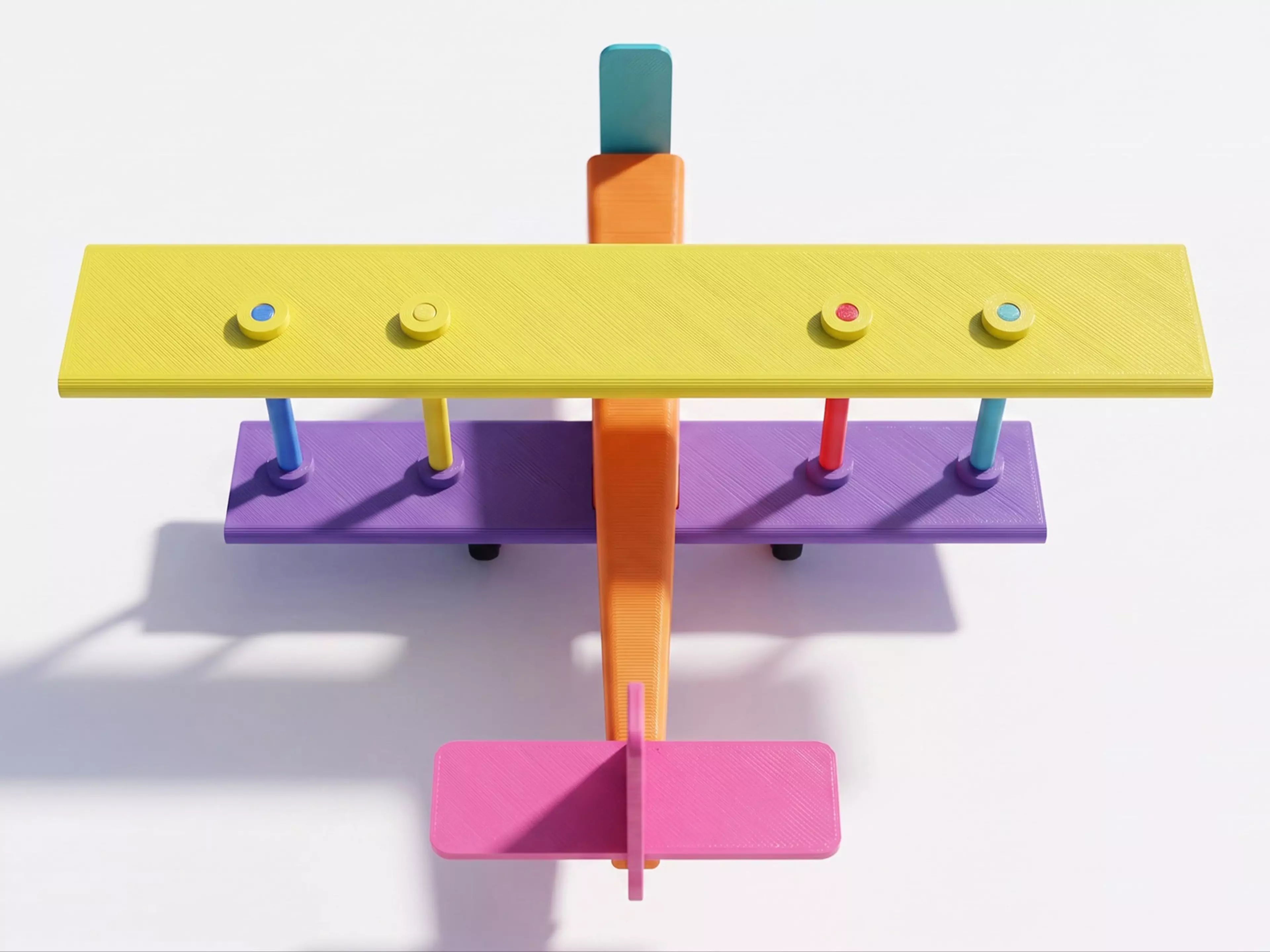 A pocket-size rubber-band-powered vintage biplane: a two-wing hand-launch glider with a free-spinning propeller driven by a twisted rubber-band motor housed in the fuselage, all in a single print color.