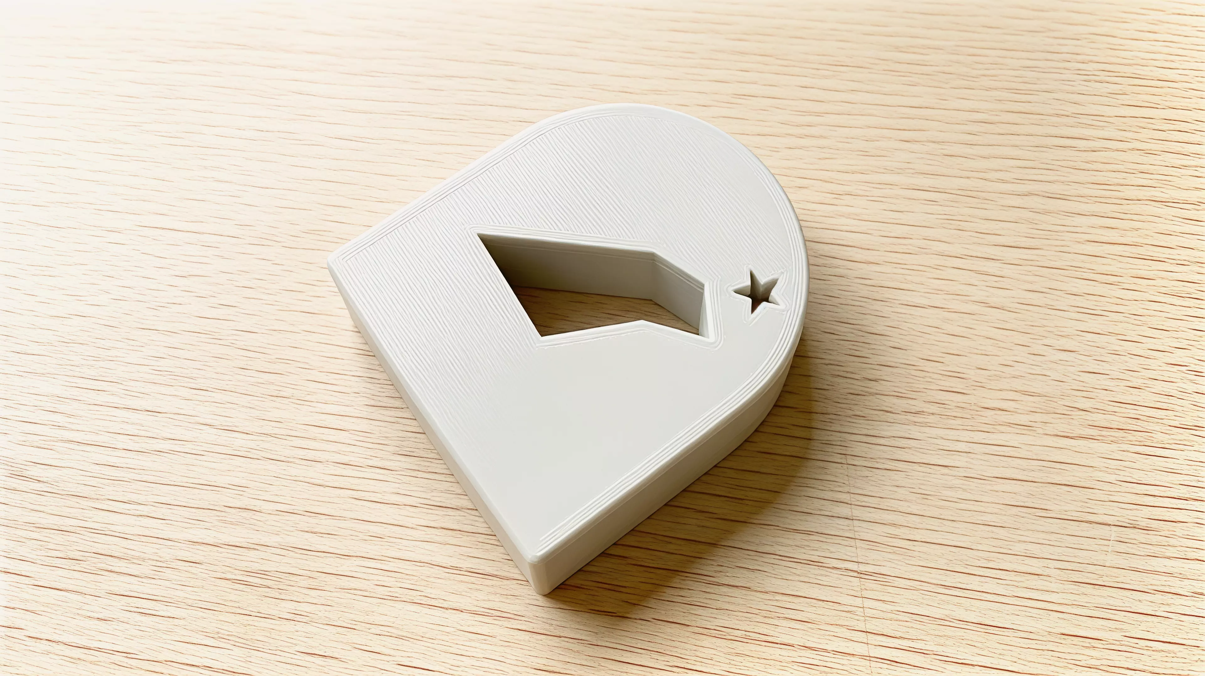 A palm-sized, one-piece rocking arch whose negative space shifts from a perched bird at rest toward a shooting-star streak in motion.