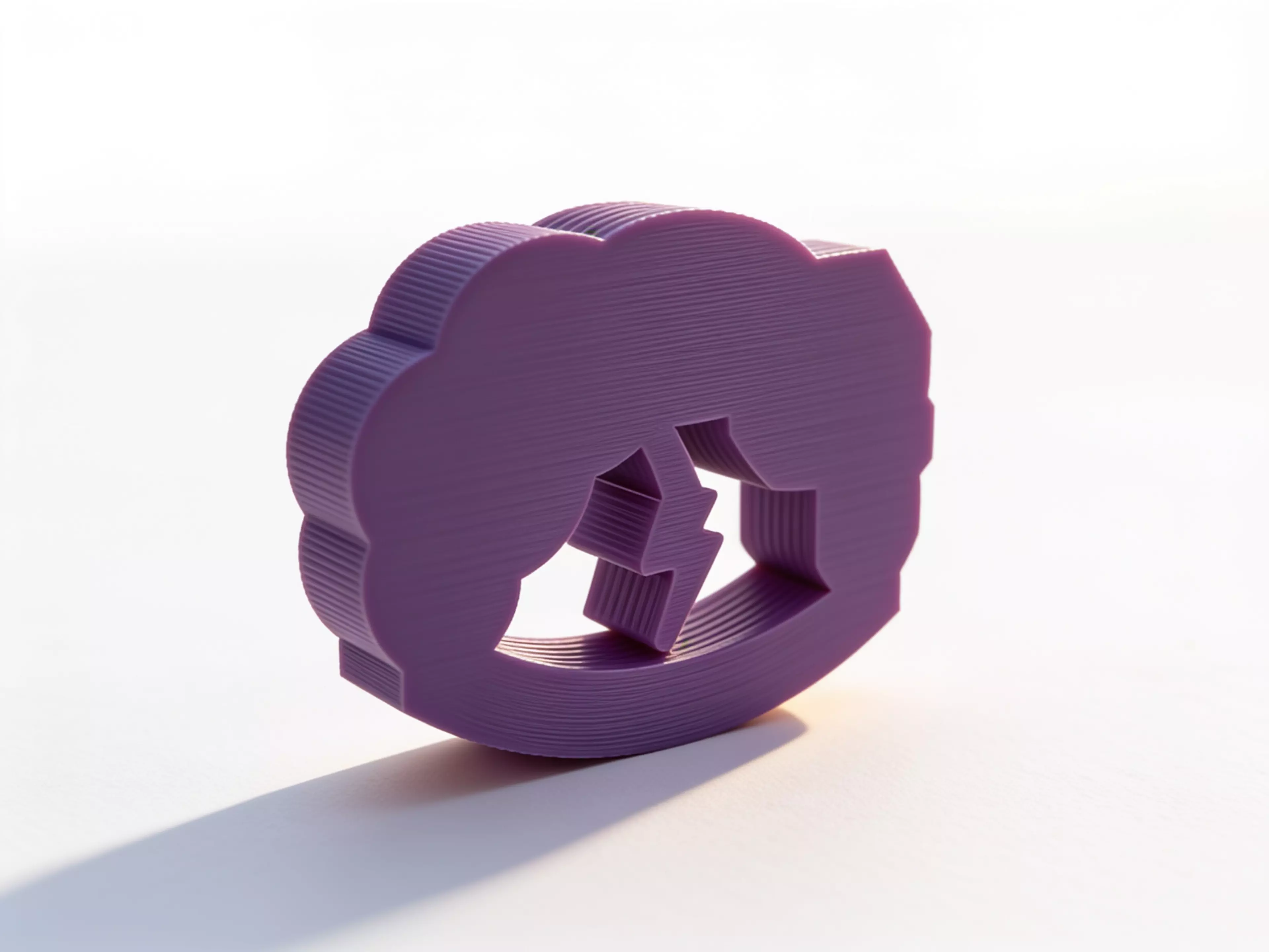 A palm-sized, one-piece storm-cloud desk rocker whose connected lightning bolt sweeps through the open arch as the whole body rocks and returns toward center.