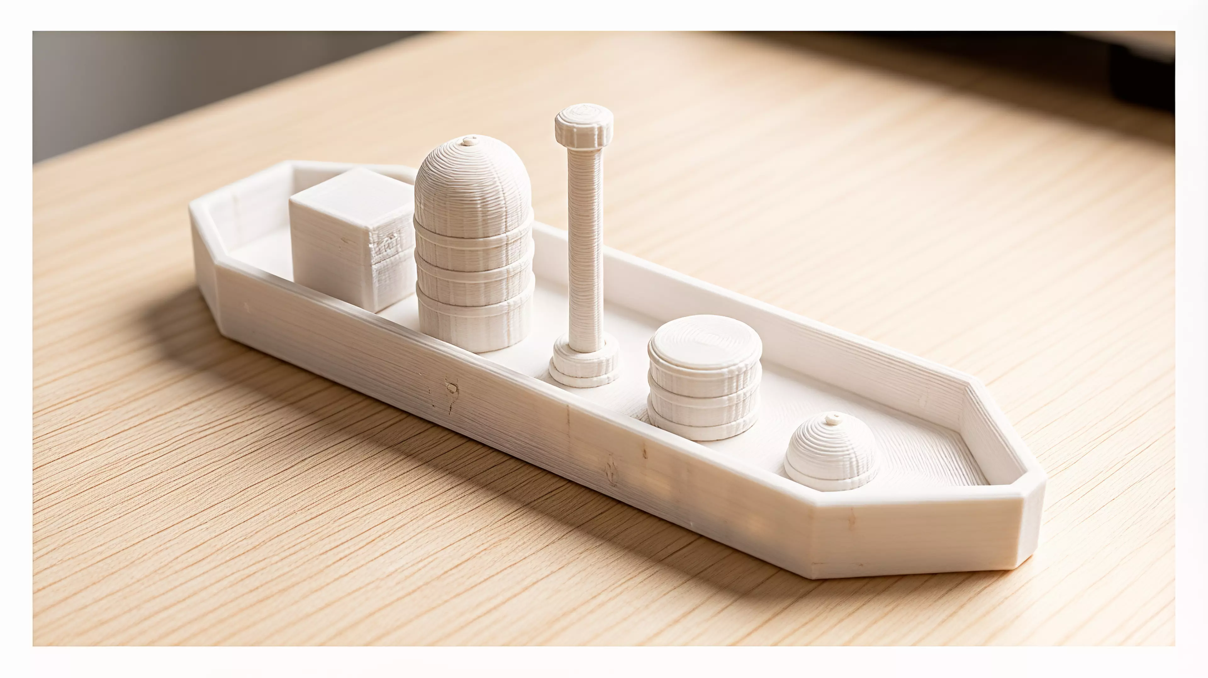A 6-part toy cargo barge: one hull plus five separate deck-cargo pieces (crate, tall tank/silo, mast, drum, dome hatch) that peg into locating bosses on the deck, in a rugged industrial-workboat style (rivets, ribbed banding, hard chamfered hull corners).