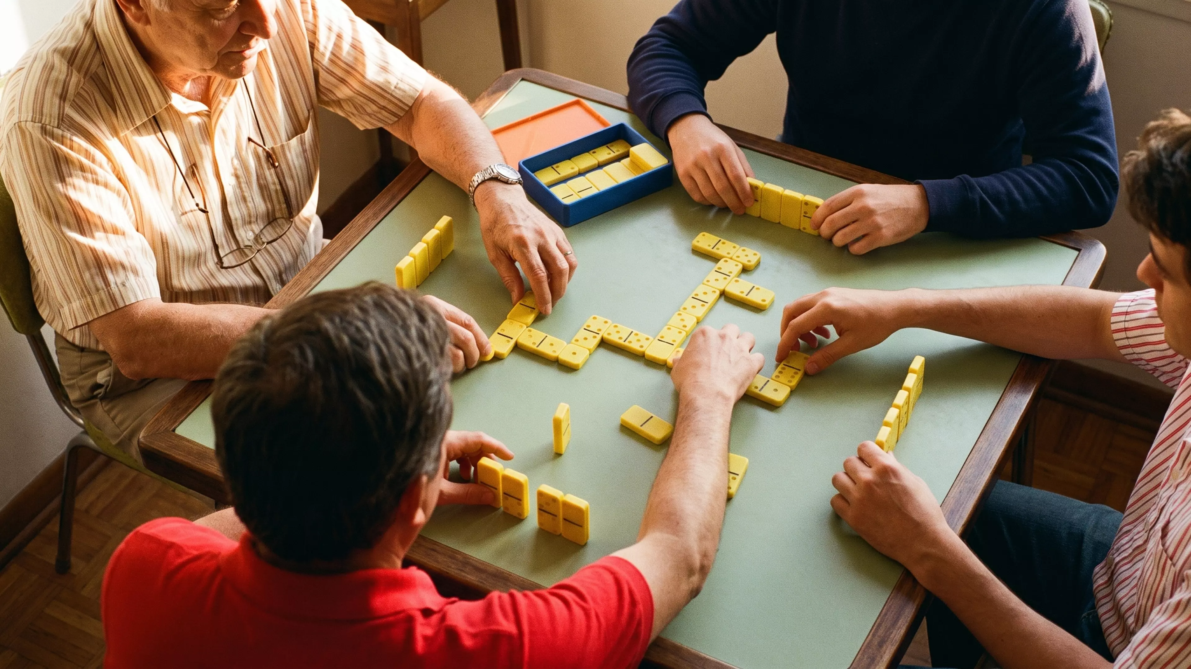 A complete Double-6 domino set — 28 tiles (48 x 24 x 8 mm) with raised embossed pips — stored in a fitted two-row tray with a slip-fit lid.