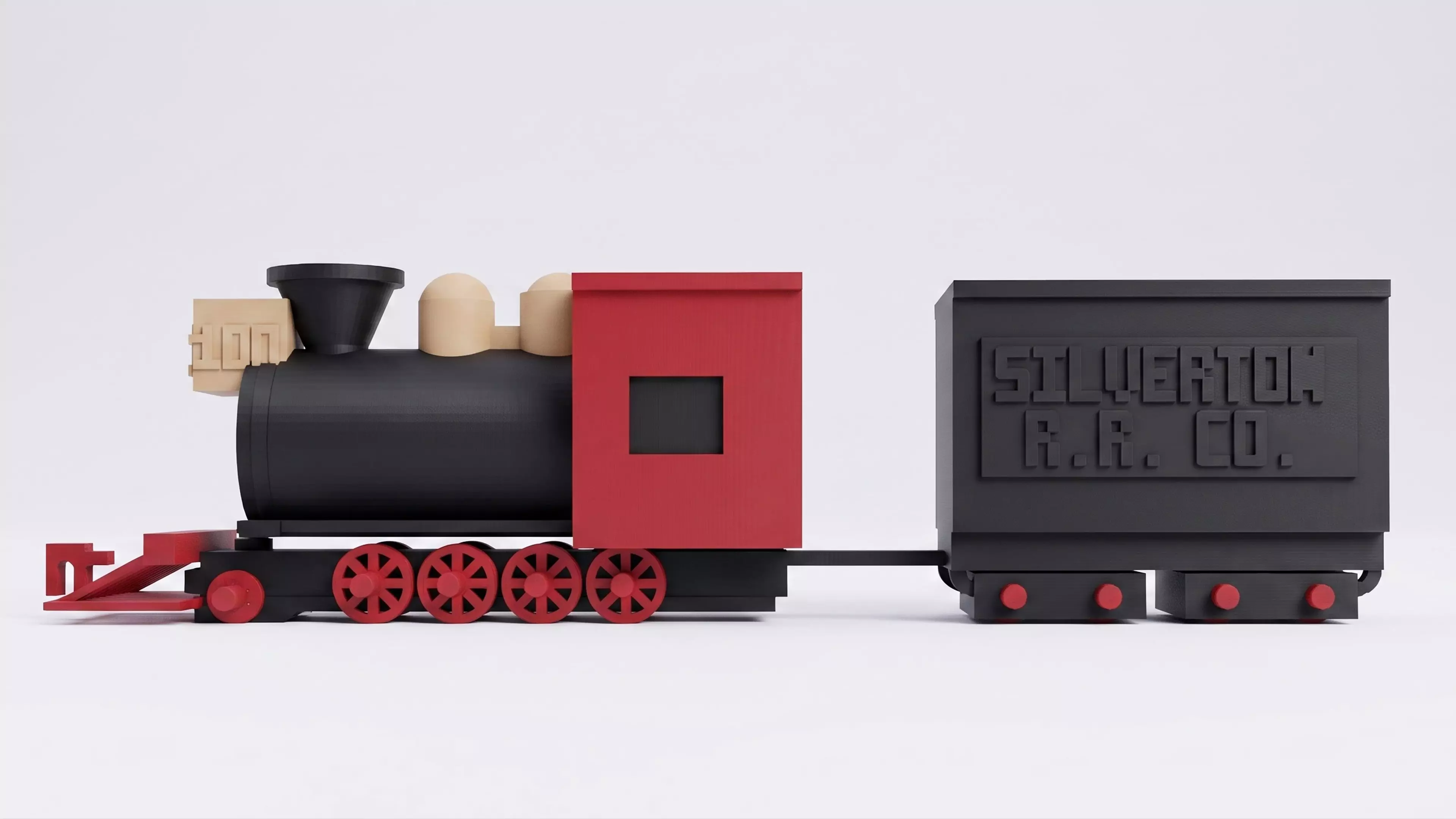 A 1:87 buildable desk model of Silverton Railroad No. 100, with a four-driver 2-8-0 profile, separate rolling wheelsets, a two-truck tender, and a hook-and-bar coupling.