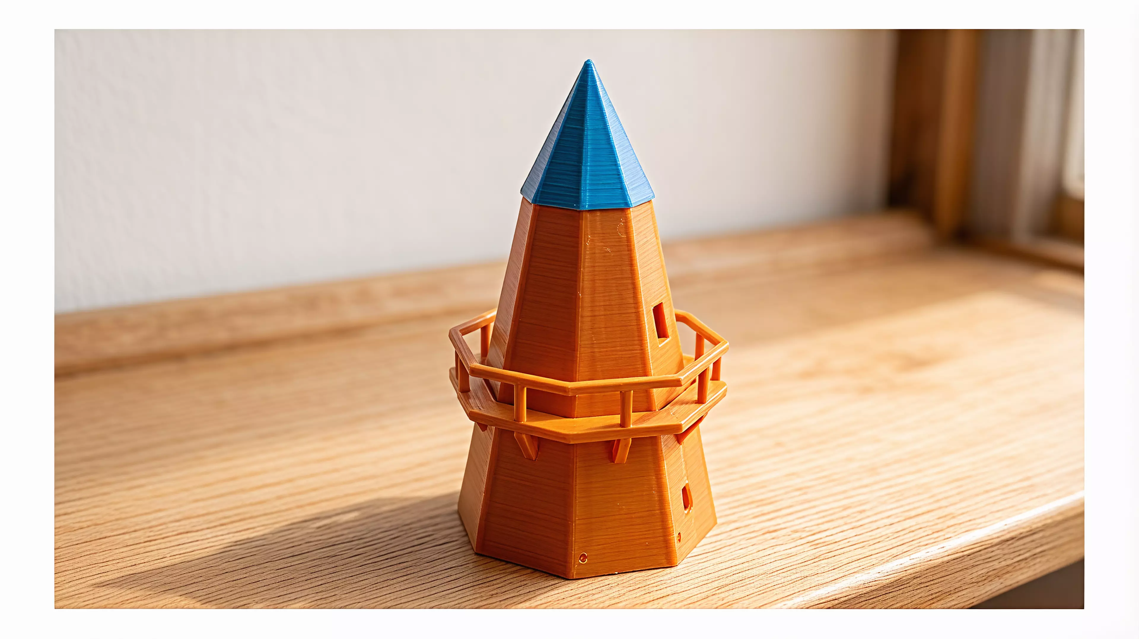 A ~250mm-tall desk windmill tea light holder in a minimal, crisp-edged style: a hollow tapered octagonal tower with an arched candle-access opening, a railed balcony, a conical cap, and a 4-blade lattice sail rotor that spins freely on a brass pin.