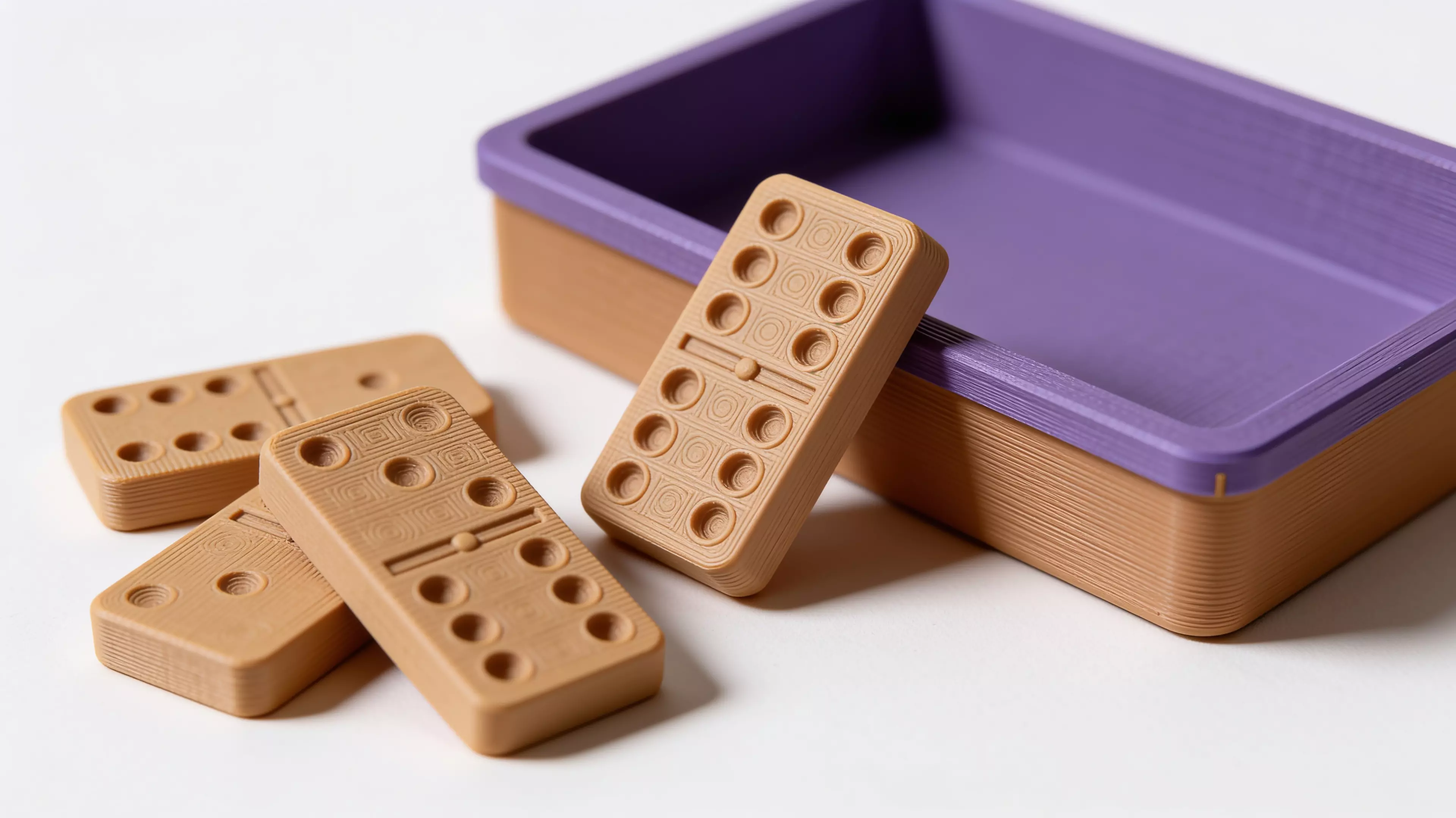 A complete Double-6 domino set — 28 tiles (48 x 24 x 8 mm) with raised embossed pips — stored in a fitted two-row tray with a slip-fit lid.