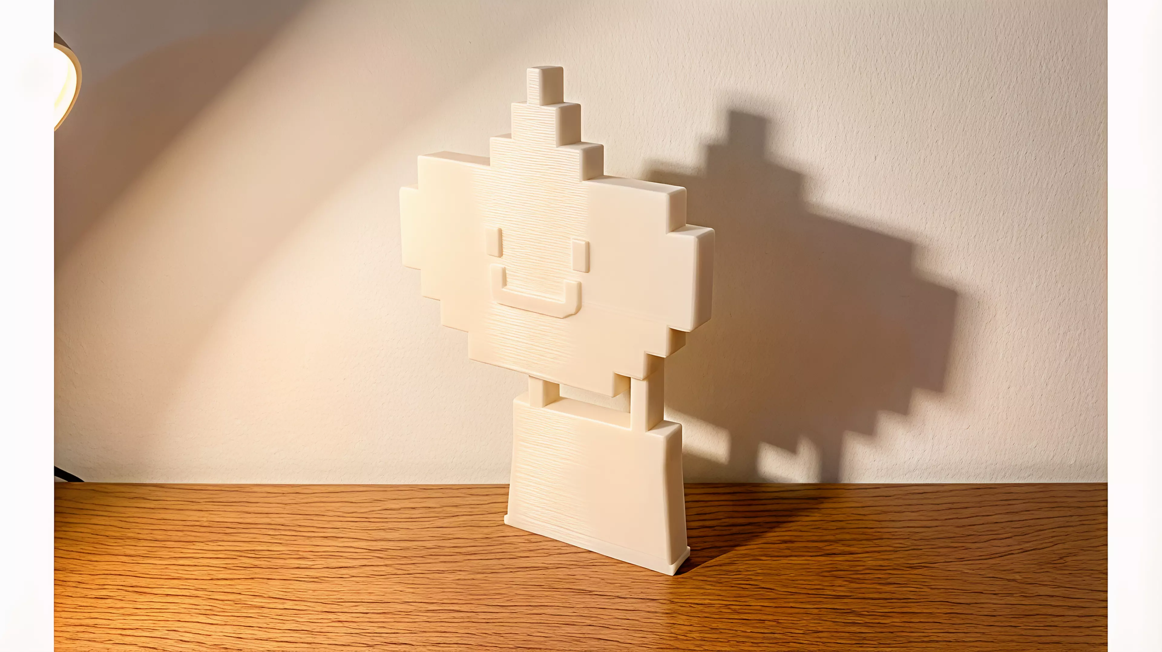 A two-part printable cupcake whose lifted frosting transforms its wall shadow into a hot-air balloon.