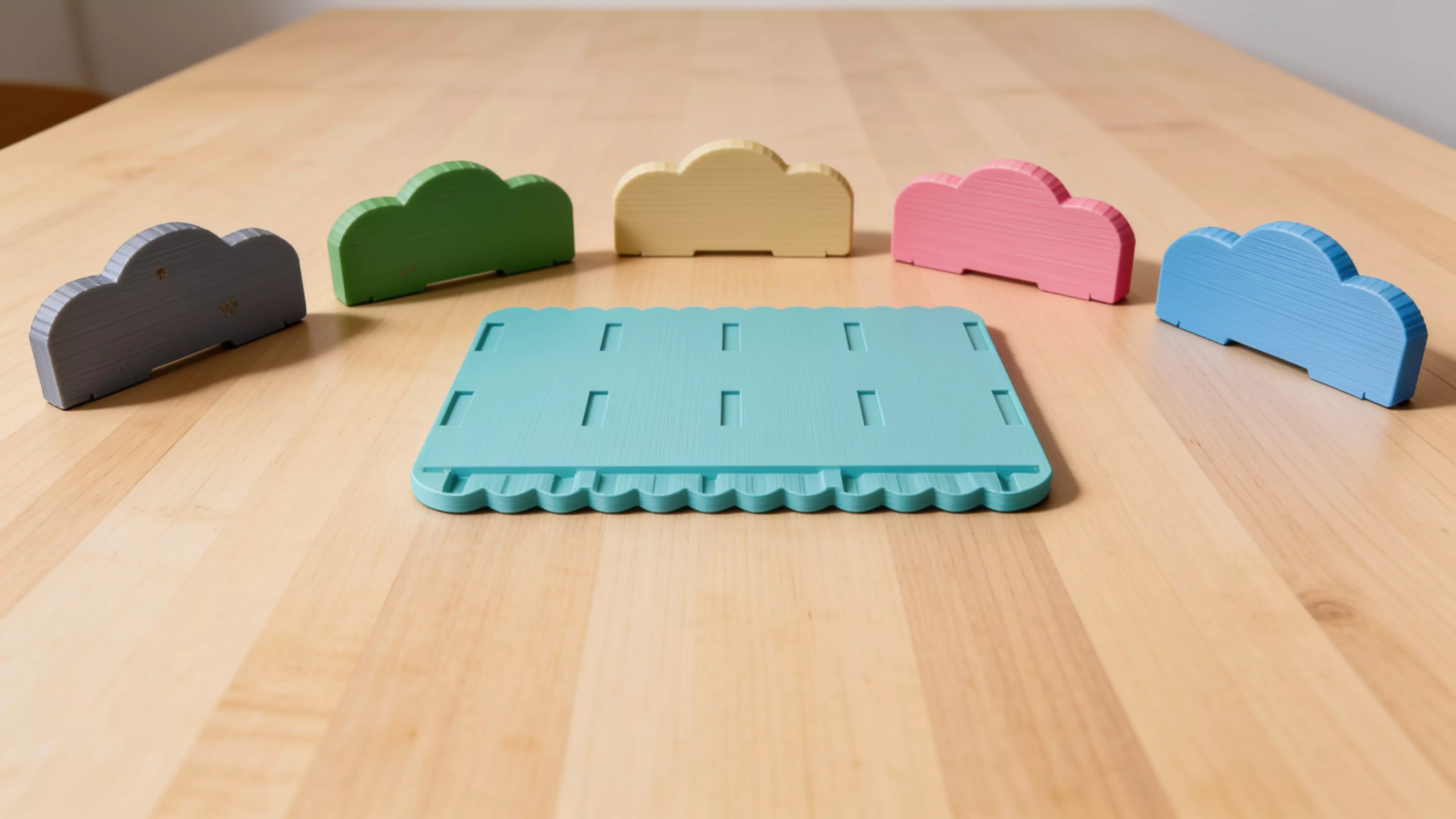 A pastel "cloud" bookshelf rack that holds 4 DGX Spark nodes upright on edge in side-by-side slots, with cloud-silhouette dividers, a scalloped base, and a rear cable-comb rail; 2 unique printed parts (base + 5 identical dividers), assembled overall 246 × 212 × 102 mm.