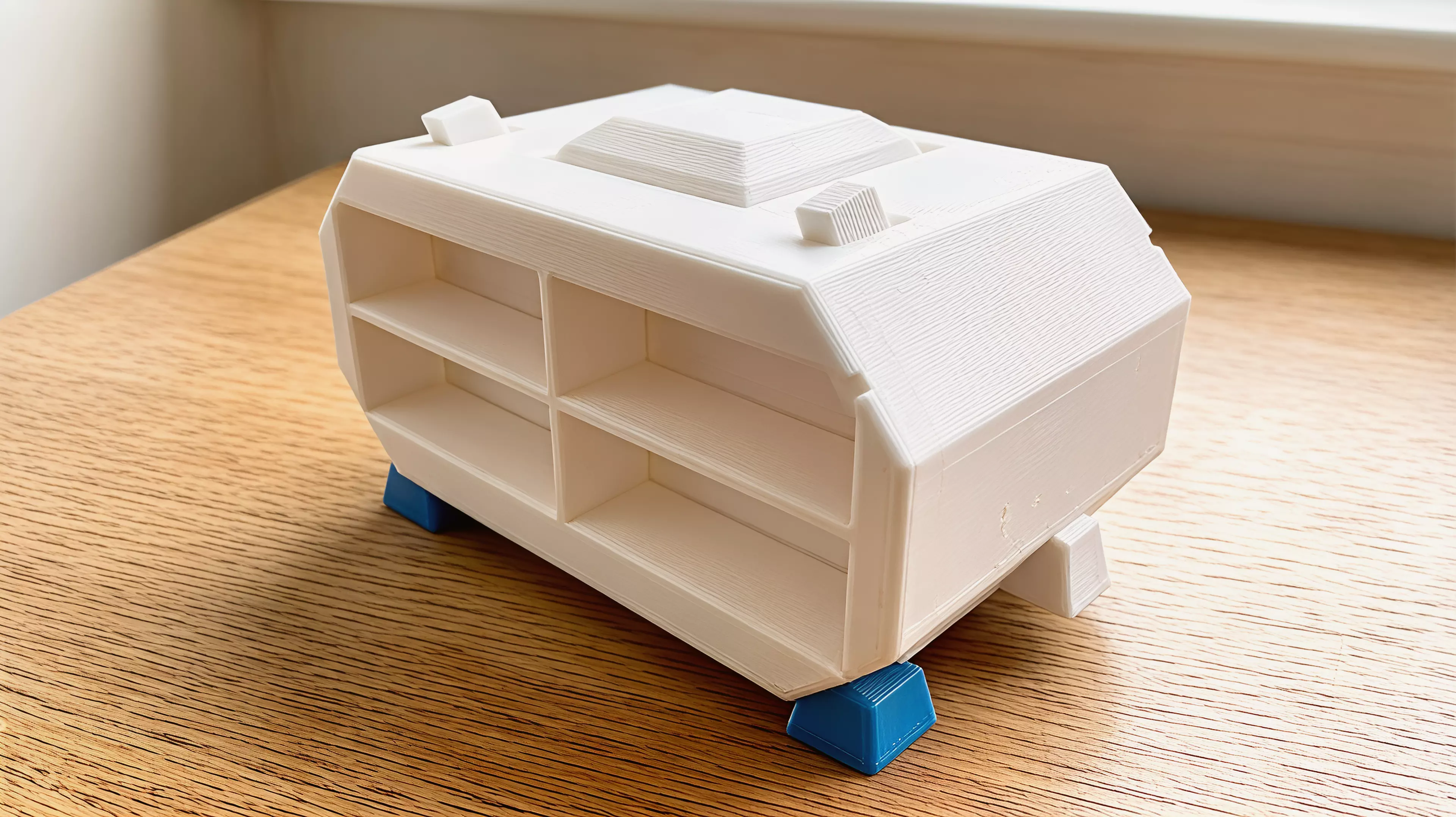 A knock-down sci-fi shuttle enclosure holding 4× NVIDIA DGX Spark in a 2×2 open-ended tunnel grid: two mirror shell halves (split on the central vertical plane), a dark-grey cockpit canopy, two swept blade fins, and four dark-grey landing feet — all M3/dowel assembled, printed without supports.